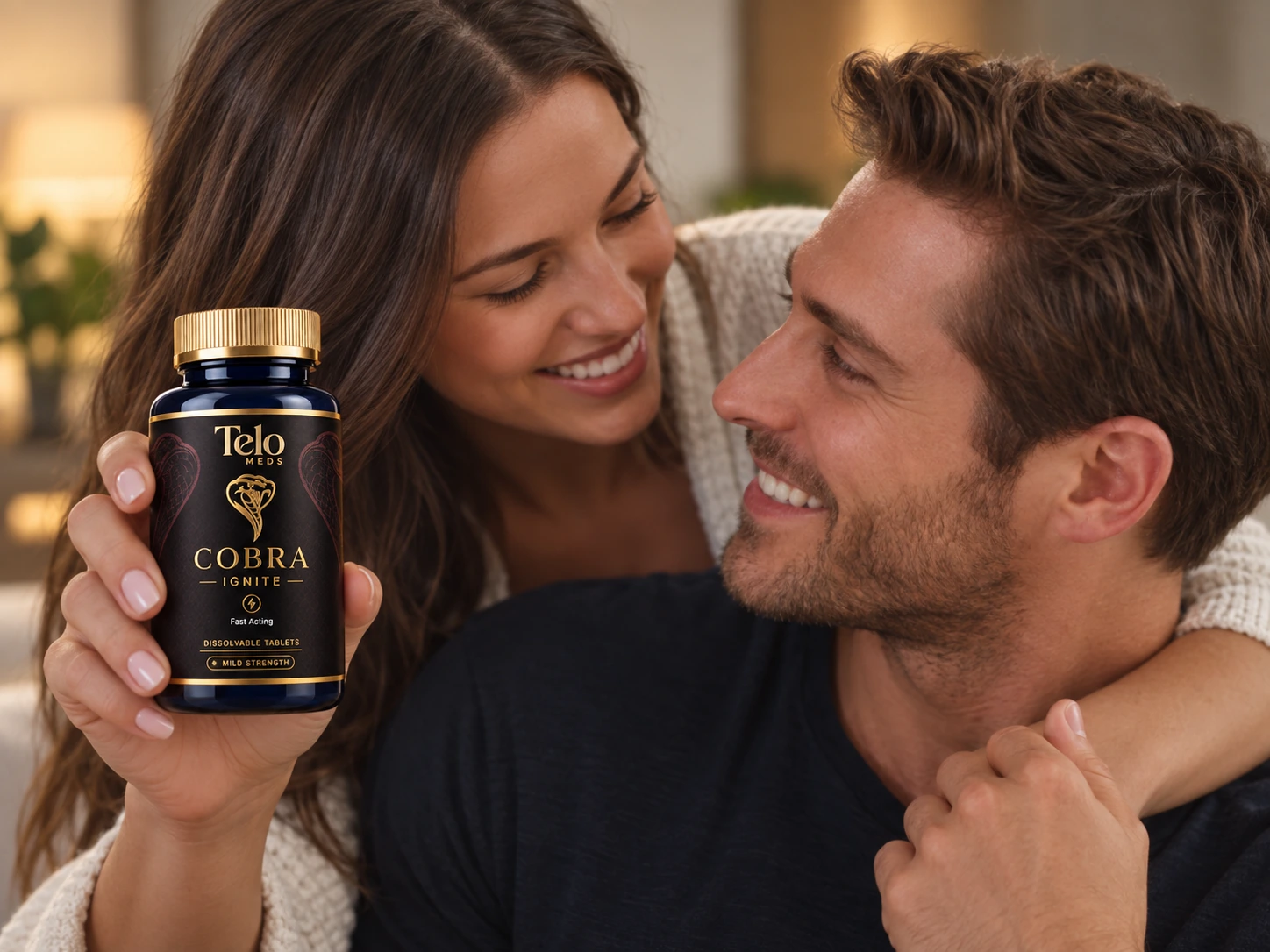 A smiling couple with a bottle of Cobra Ignite